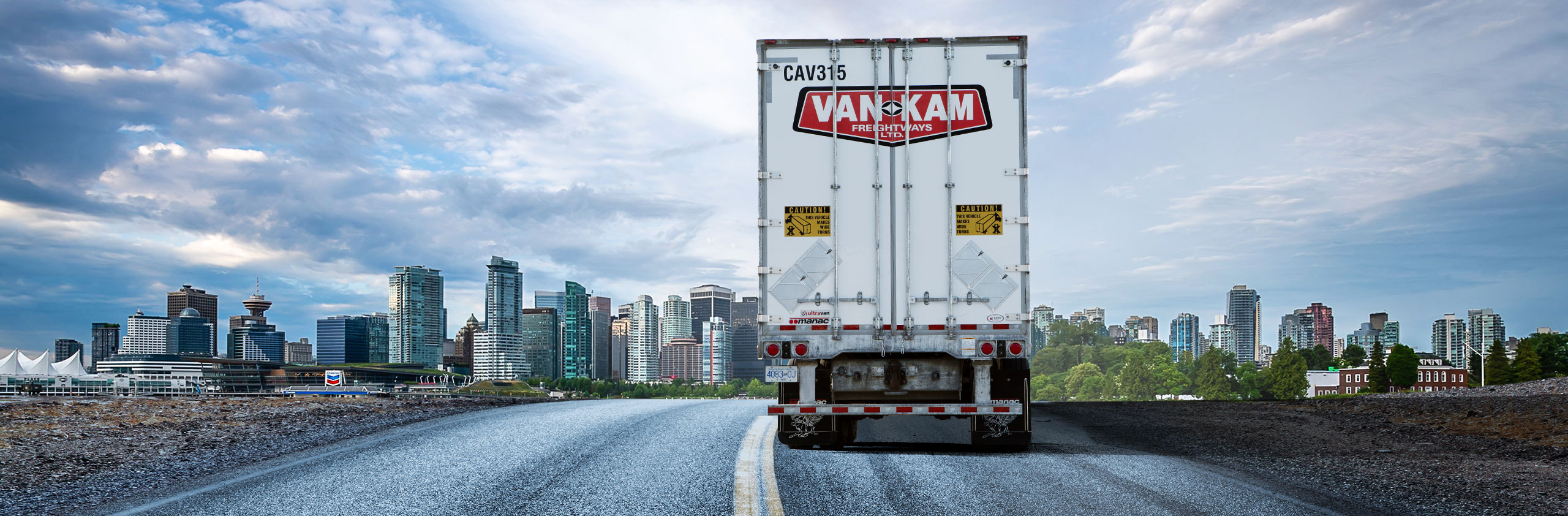Back view of Van Kam trailer driving into Vancouver