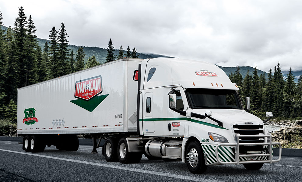 Van Kam highway truck with hazardous freight placards on trailer
